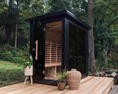 a wooden deck with a hot tub on top of it and plants in the foreground