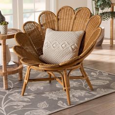 a wicker chair sitting on top of a rug in a living room next to a table