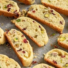 several pieces of bread with nuts and cranberry toppings