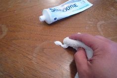 someone is cleaning the table with toothpaste on it, and there are other things to do