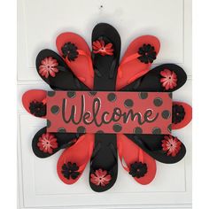 a welcome sign with flip flops and flowers on it