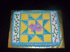 a birthday cake with the number 90 on it's side and decorated in blue and yellow