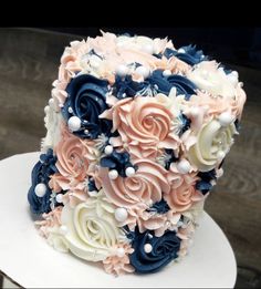 a wedding cake decorated with flowers and pearls