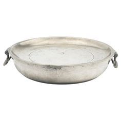 an oval silver tray with handles on the bottom and two handles at the top,