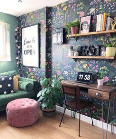 a living room filled with furniture next to a wall covered in floral wallpapers