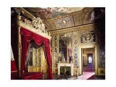 an ornately decorated bedroom with red drapes