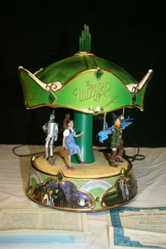 a carousel with figurines sitting on top of it