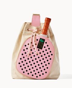 a pink and white bag with a bottle in it's pocket on the side