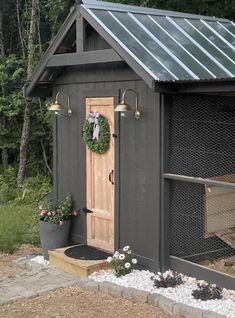 a chicken coop with a wreath on the door