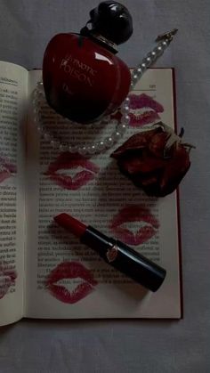 an open book with lipstick on it