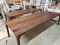 two wooden tables sitting next to each other in a room