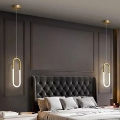 a large bed sitting next to a window in a room with two lights hanging from the ceiling