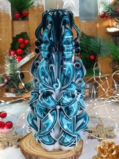 a blue and white vase sitting on top of a wooden table next to christmas decorations