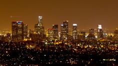 the city skyline is lit up at night