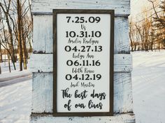 a sign that is on the side of a building in the snow with dates and times