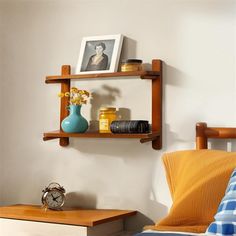 a bedroom with a bed and shelves on the wall