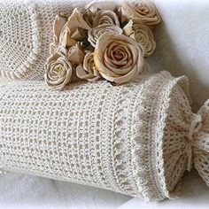 two crocheted pillows with roses on them