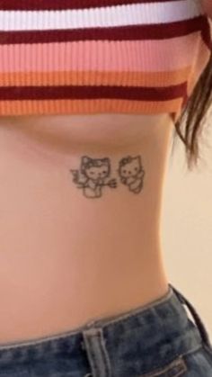 a woman's stomach with an owl tattoo on her left side ribcage