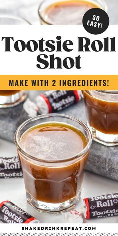 two glasses filled with hot chocolate sitting on top of a white table next to candy bars