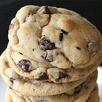 a stack of chocolate chip cookies sitting on top of a white plate