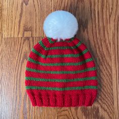 a red and green striped hat with a white pom