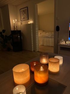 lit candles sit on a table in front of a television