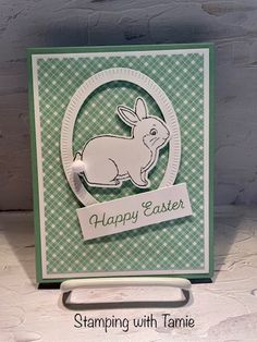 a green and white card with a rabbit on it