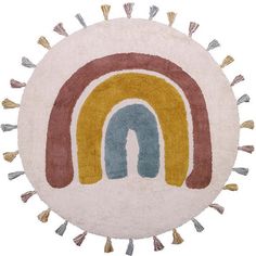 a round rug with a rainbow design on the center and tassels around it