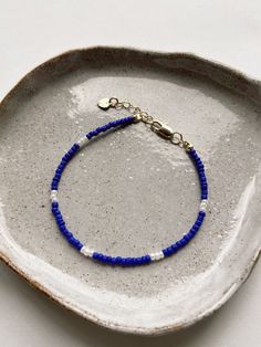 a blue beaded bracelet on a white plate