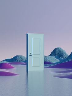 an open door in the middle of a desert with mountains and blue sky behind it