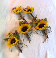 five sunflowers are arranged on a white sheet