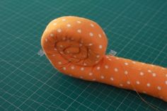 an orange object with white polka dots on it