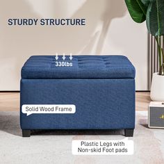 a blue ottoman sitting on top of a white floor next to a plant and radio