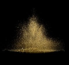 a large amount of gold glitter on a black background