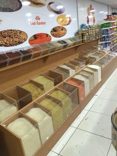 a store filled with lots of different types of food in bins next to each other