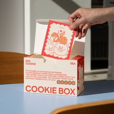 a person is opening up a cookie box