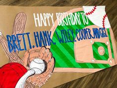 a paper bag with a baseball glove and ball on it that says happy birthday to britt hank