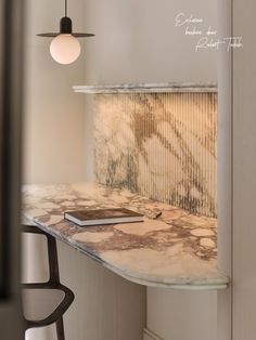 a marble counter top with a book on it