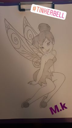 a drawing of a tinkerbell sitting on top of a piece of paper