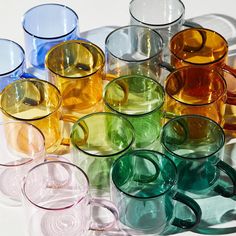 many different colored glasses sitting on top of each other