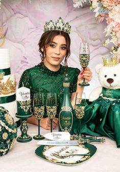 a woman holding a wine glass in front of two champagne glasses and a teddy bear