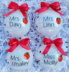 two glass ornaments with red bows on them and the words mrs & mr / m / ln