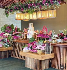 the table is covered with flowers and desserts for guests to sit down at it