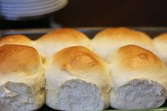 rolls with white frosting sitting in a baking pan