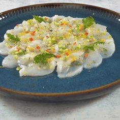 a blue plate topped with food on top of a table