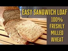 two loaves of bread sitting on top of a wooden cutting board with the words easy sandwich loaf 100 % freshly milled wheat