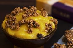 a dessert dish with granola and cheese on top