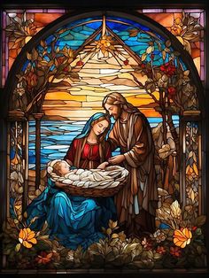 a stained glass window depicting the birth of jesus and baby jesus in a manger