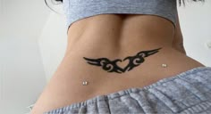 a woman's stomach with a tattoo design on her lower back and upper half