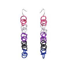 two pairs of multicolored earrings hanging from silver hooks on white background with clippings